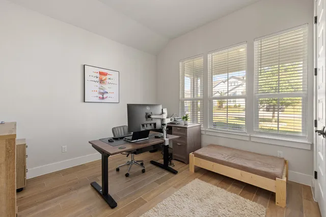 a view of a workspace with lounge chair and a window