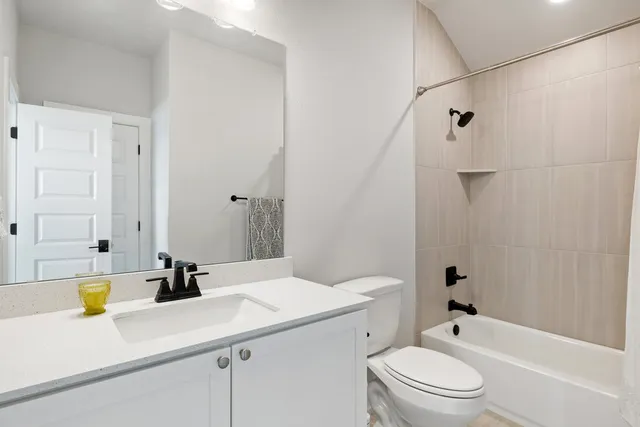 a bedroom with bed and painting on the wall