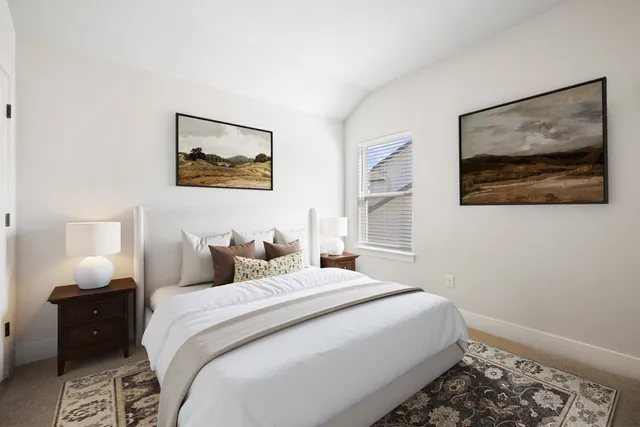 a bedroom with a bed and a painting on the wall