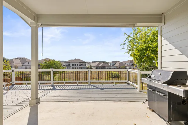 a view of balcony with wooden floor and seating space