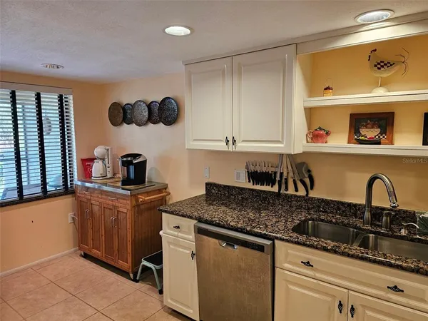 a kitchen with stainless steel appliances granite countertop a sink and cabinets