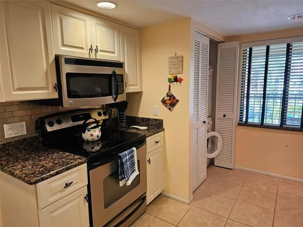 a kitchen with a stove and a microwave