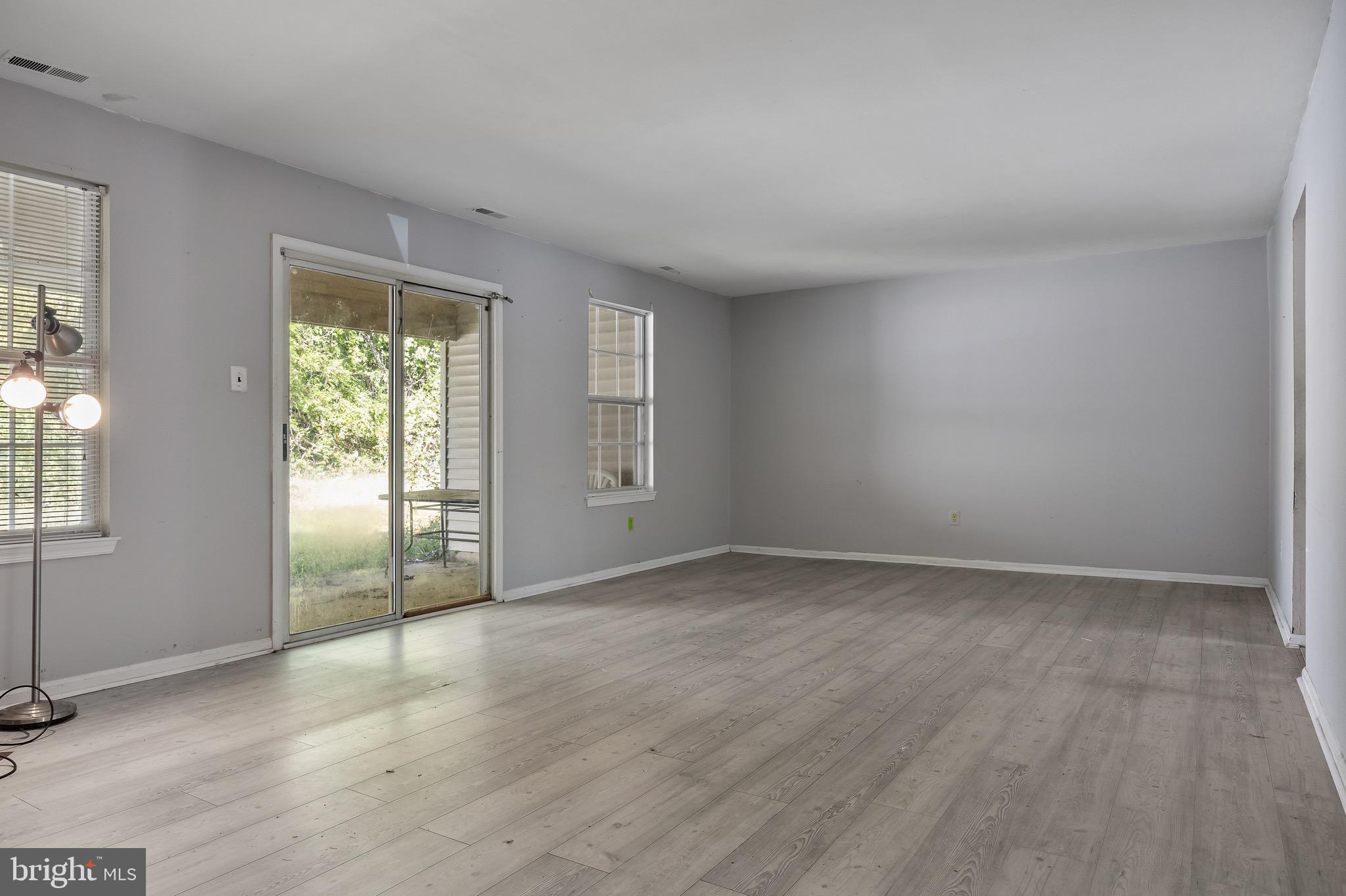 13 Summit Court Clementon, NJ 08021 - Photo 4 of 6 an empty room with wooden floor and windows