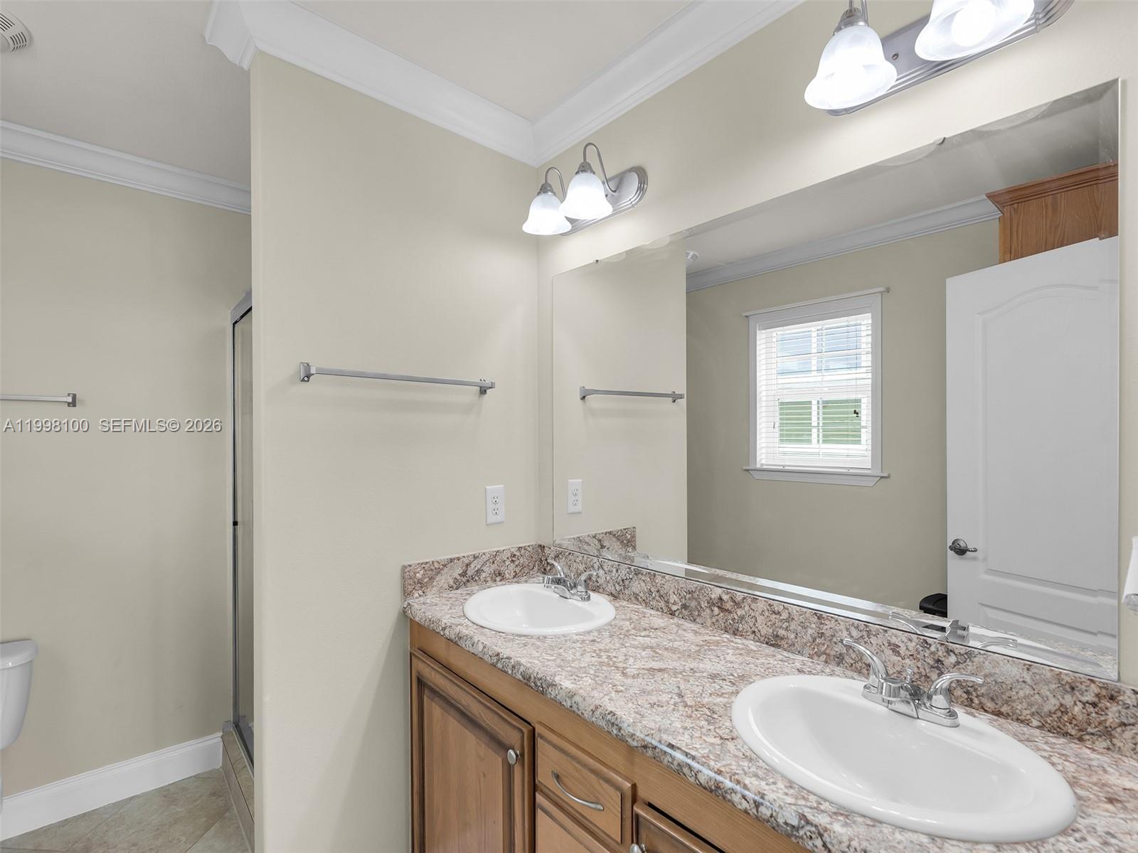 437 Pirates Road Summerland Key, FL 33042 - Photo 27 of 39 a bathroom with a granite countertop sink a light fixture and a mirror