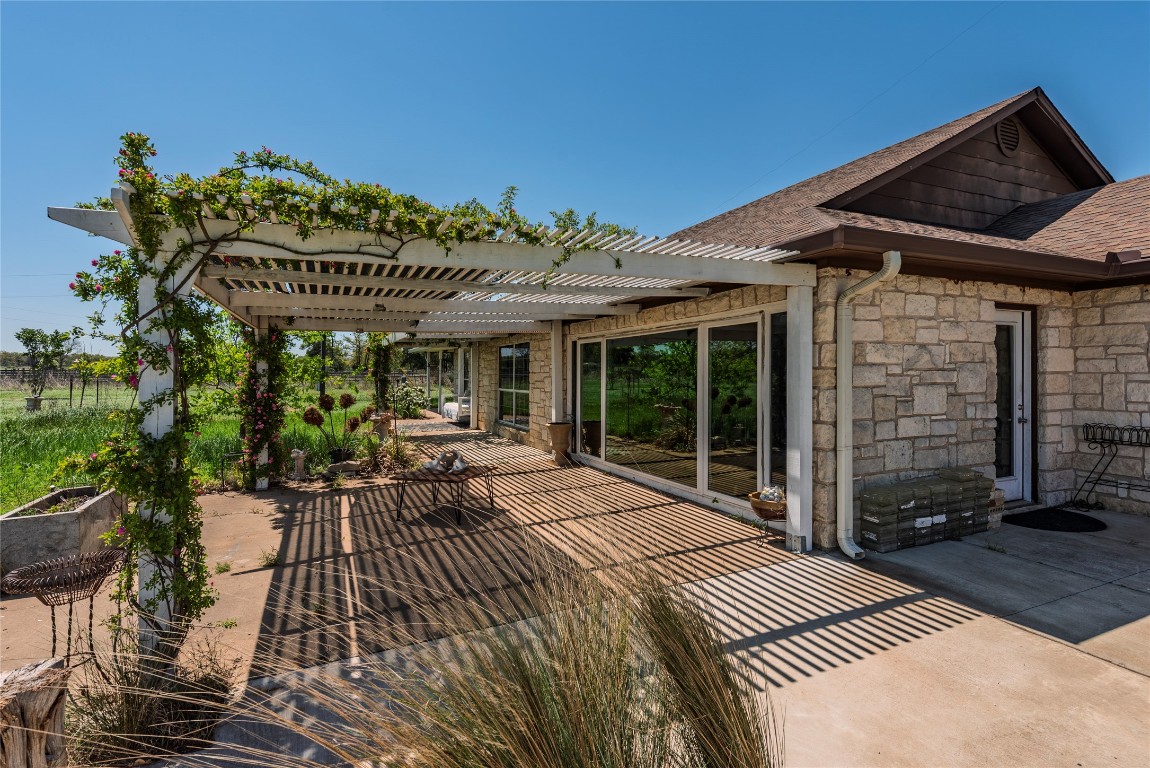 a view of a patio with table and chairs with wooden floor and fence