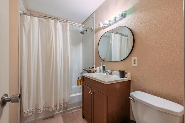 a bathroom with a toilet a sink and a mirror