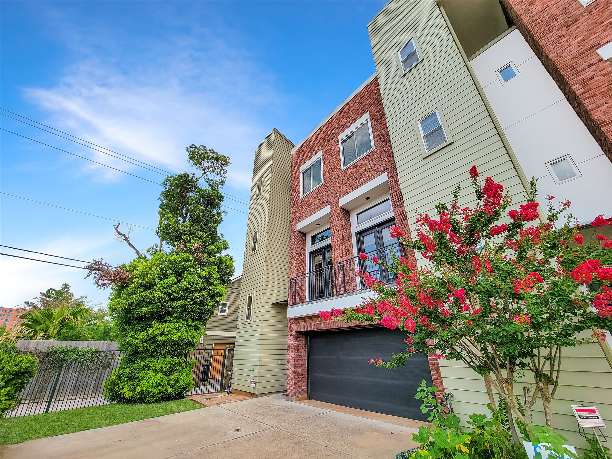 This townhouse has 3 bedrooms, 2 & 1/2 baths, a two car garage, a double driveway, two balconies and a rooftop deck.
