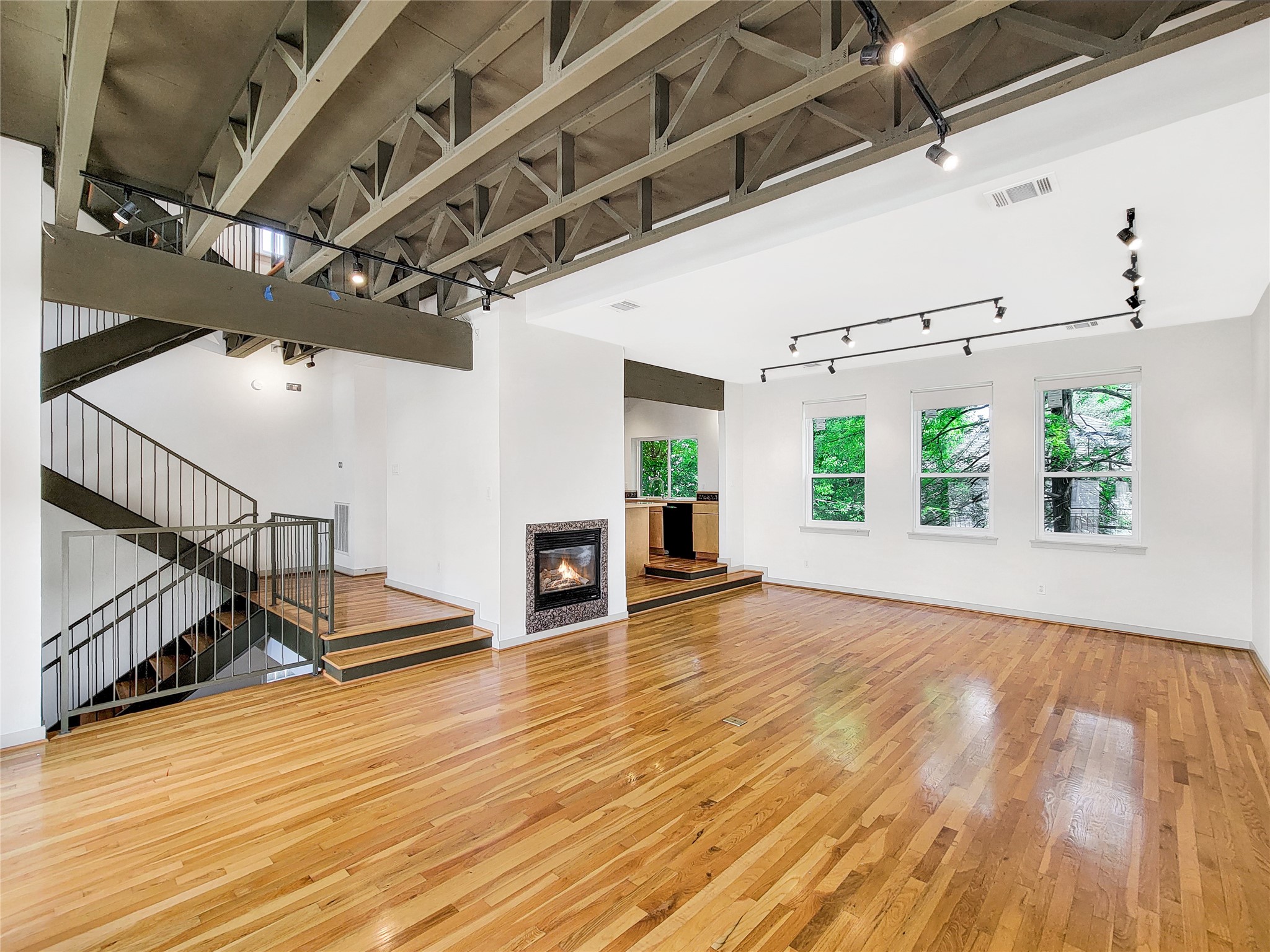 321 East 20th Street Houston, TX 77008 - Photo 4 of 36 The 2nd floor living/dining/kitchen is open with an industrial chic design. Open ceilings, wood floors and fireplace make this a great space for entertaining.