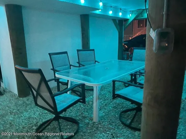 a dining room with furniture and a potted plant