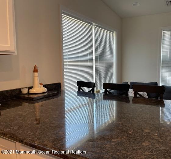 121 West Tide Way Lavallette, NJ 08735 - Photo 19 of 20 a living room with couches and kitchen view with wooden floor
