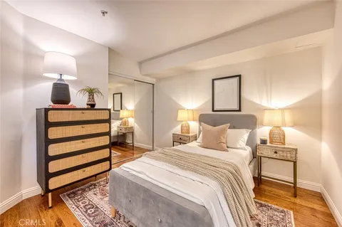 a bedroom with a bed and a night stand