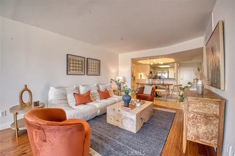 a living room with furniture a rug and a large window