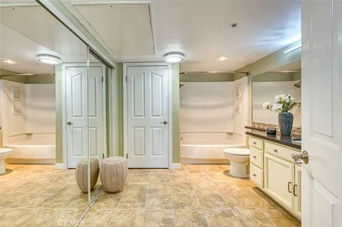 a bathroom with a tub shower and sink