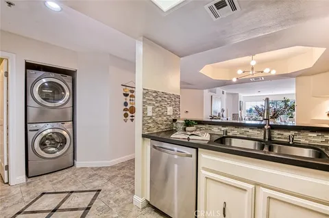 a view of a storage and utility room with washer and dryer