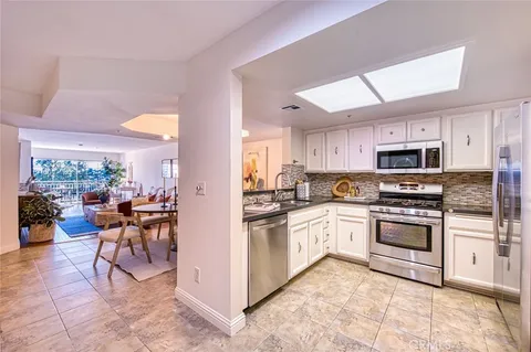 a kitchen with a sink and white appliances