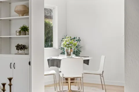 a bedroom with a bed and a potted plant