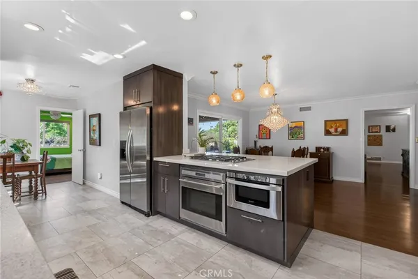 a kitchen with stainless steel appliances granite countertop a stove and a refrigerator