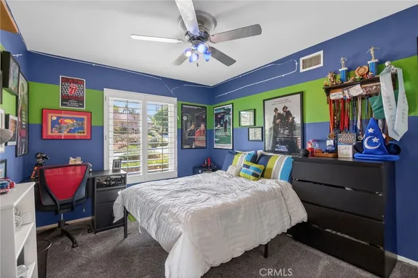 a bed room with a bed mirror and a window