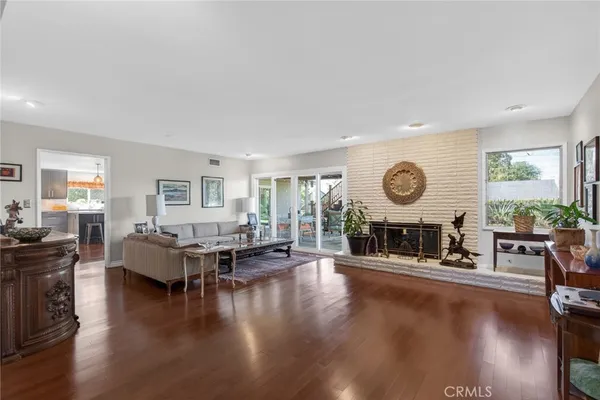 a living room with fireplace furniture and wooden floor