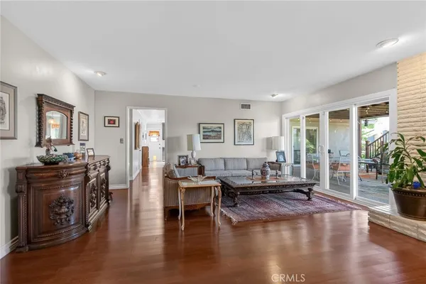 a living room with fireplace furniture and a wooden floor
