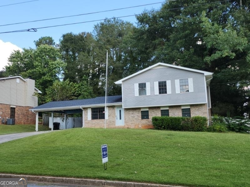 a front view of a house with a yard