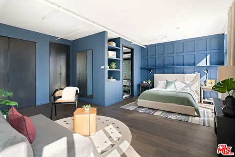 a bedroom with a bed and dresser