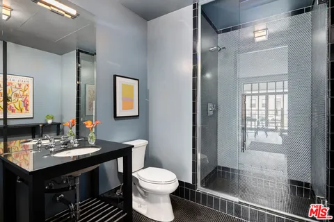 a bathroom with a sink toilet and shower