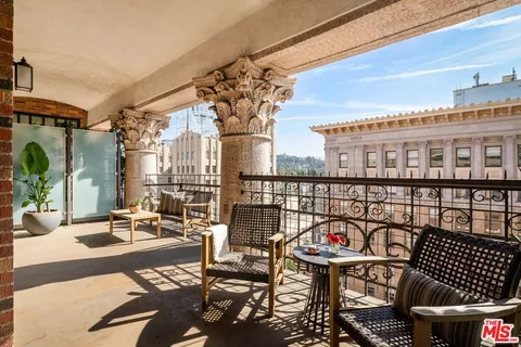 a view of a balcony with chairs