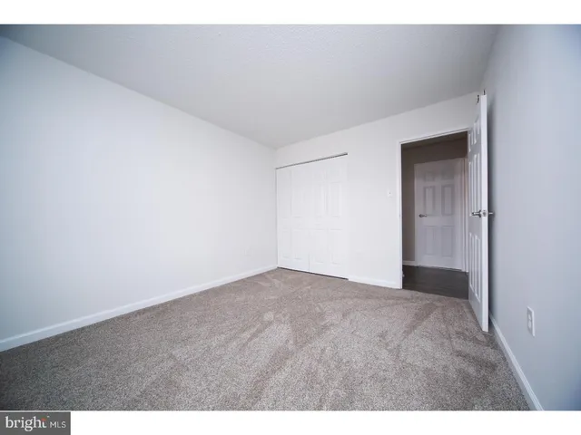 a view of an empty room and closet