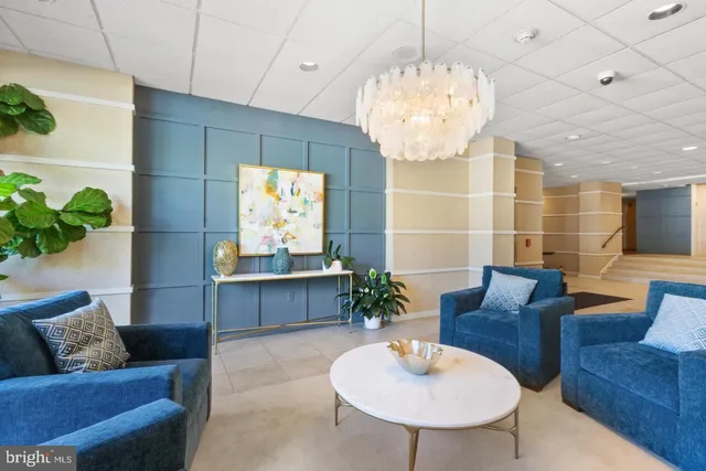 a living room with furniture and a chandelier