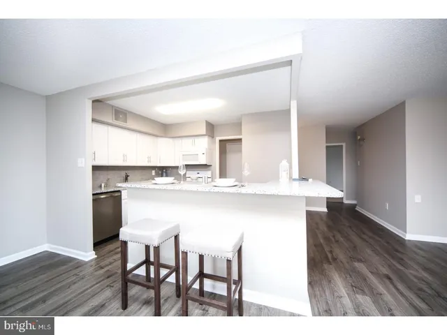 a kitchen with kitchen island wooden cabinets and counter space