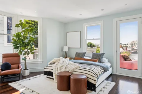 a view of a living room with wooden floor