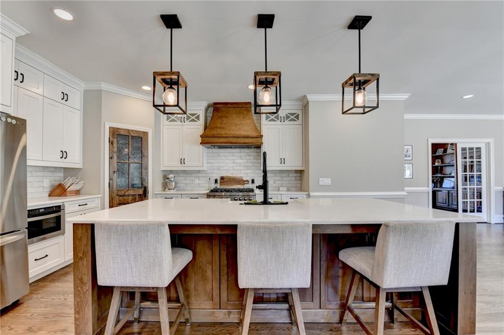 2853 Brookside Drive Monroe, GA 30656 - Photo 18 of 76 a kitchen with stainless steel appliances granite countertop a table chairs and a refrigerator