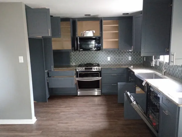 a kitchen with a sink and a stove top oven