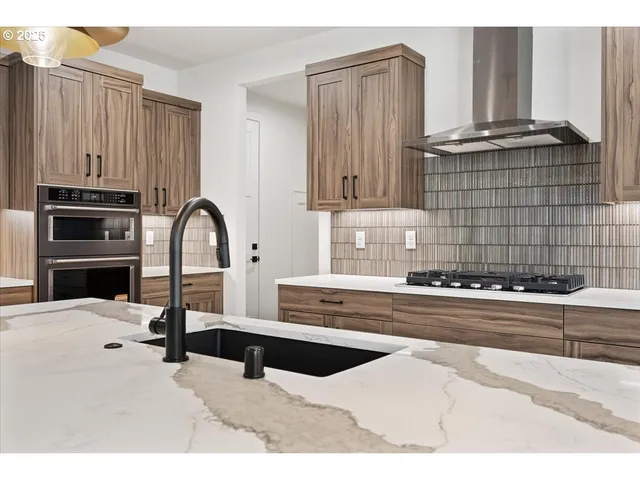 a kitchen with a refrigerator and a stove