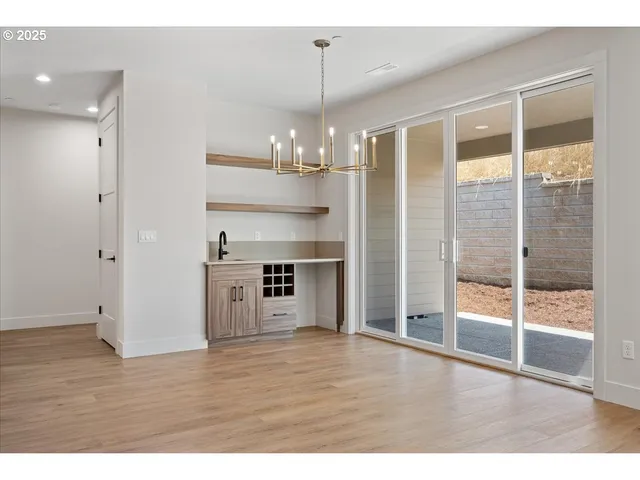 a view of a kitchen with wooden floor and a ceiling fan