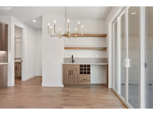 a open kitchen with kitchen island a stove a refrigerator and a view of living room