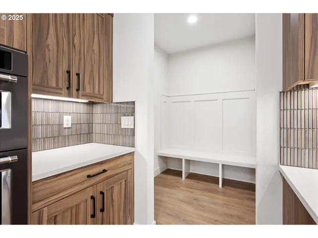 a kitchen with a sink cabinets and a wooden floor