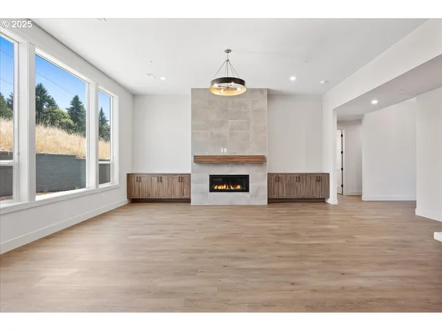 a view of a room with wooden floor and fireplace