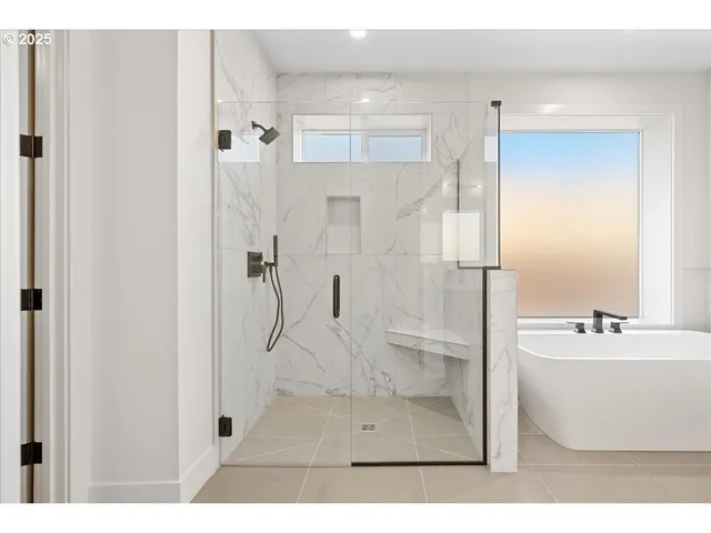 a bathroom with a tub shower sink and mirror
