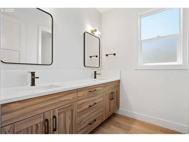 a bathroom with a double vanity sink and a mirror