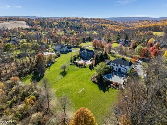 a aerial view of a house next to a yard