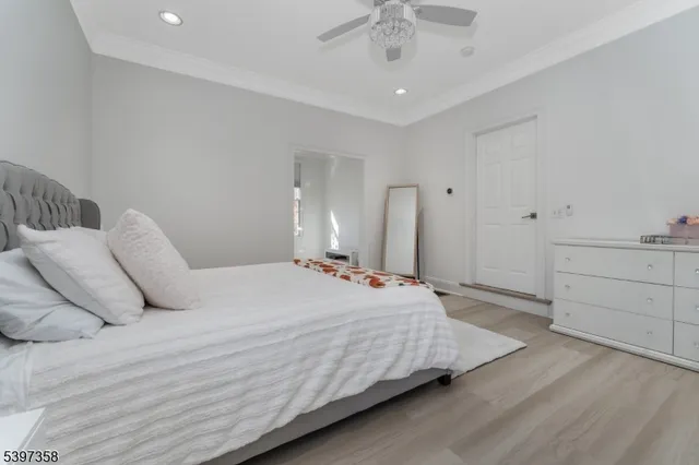 a bedroom with furniture and wooden floor
