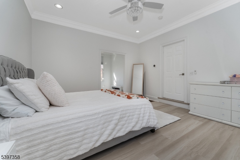 16 Perry Road Annandale, NJ 08801 - Photo 35 of 49 a bedroom with a bed and a chandelier