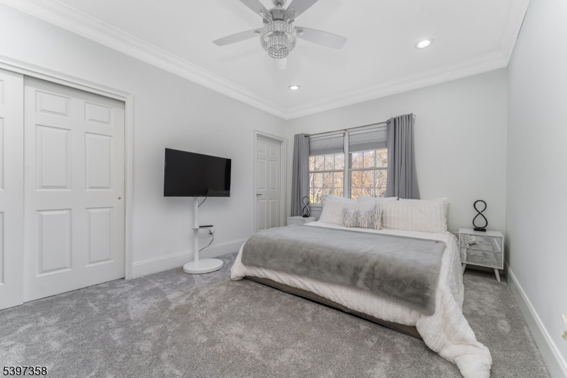 16 Perry Road Annandale, NJ 08801 - Photo 45 of 49 a bedroom with a bed and a flat screen tv