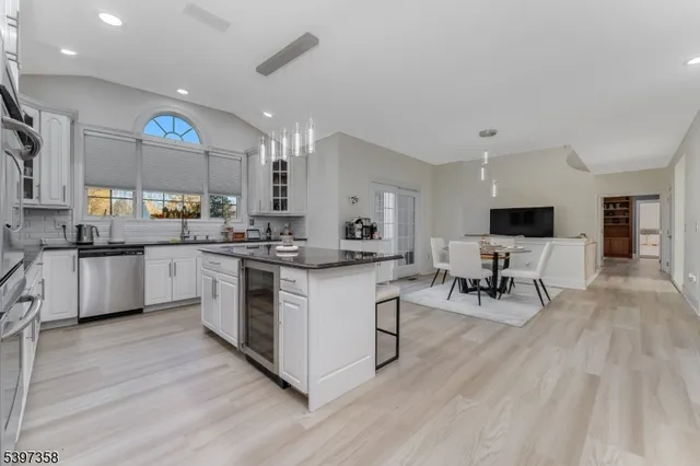 a kitchen with a sink cabinets and wooden floor