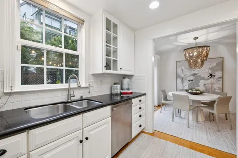 a kitchen with a sink cabinets and window