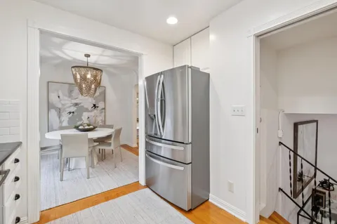 a kitchen with stainless steel appliances a refrigerator and a stove top oven