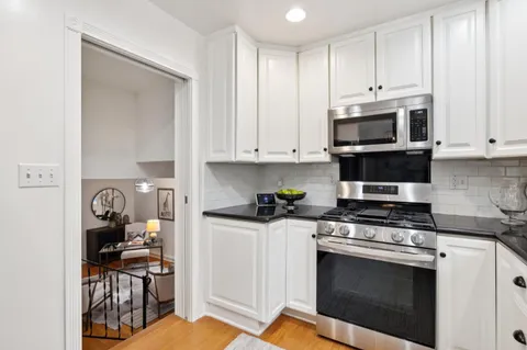 a kitchen with stainless steel appliances a stove a microwave and cabinets