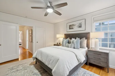 a bedroom with a bed and a chandelier